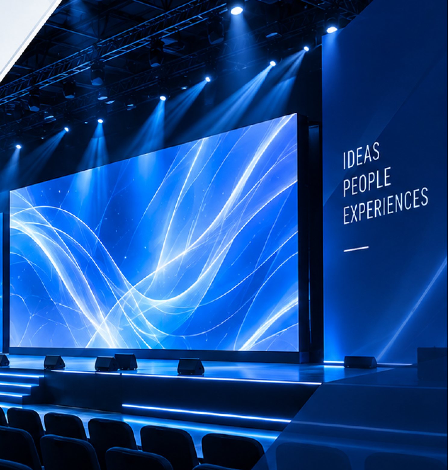 Wide LED screen and stage lighting in a conference hall